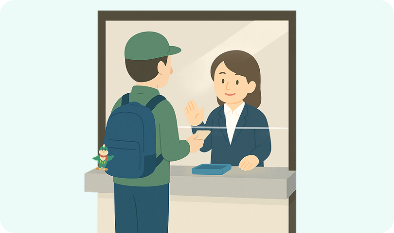 駅の窓口で係員から乗車券を購入している様子